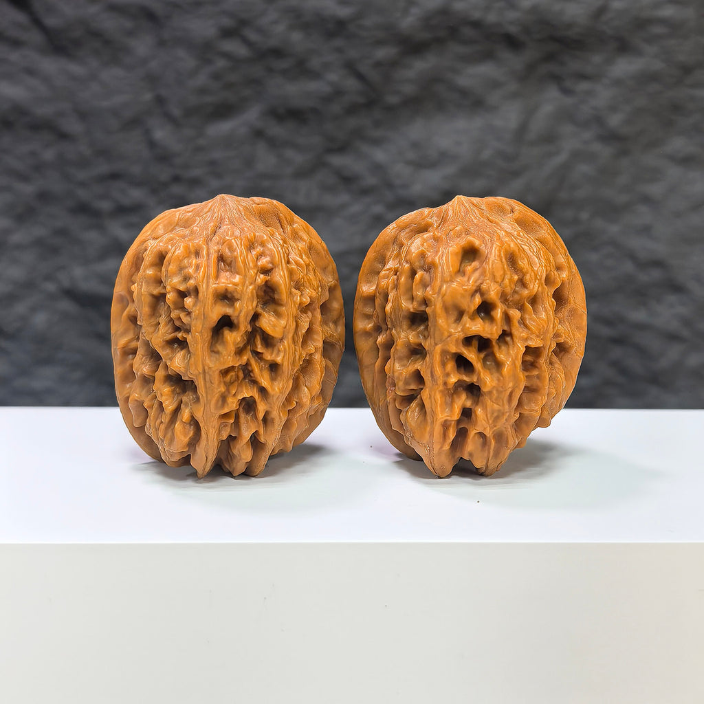 Pair of Pinggu Golden Hammer Wenwan walnuts from Wenwan Art, 39mm x 41mm, featuring smooth, polished walnut surfaces.