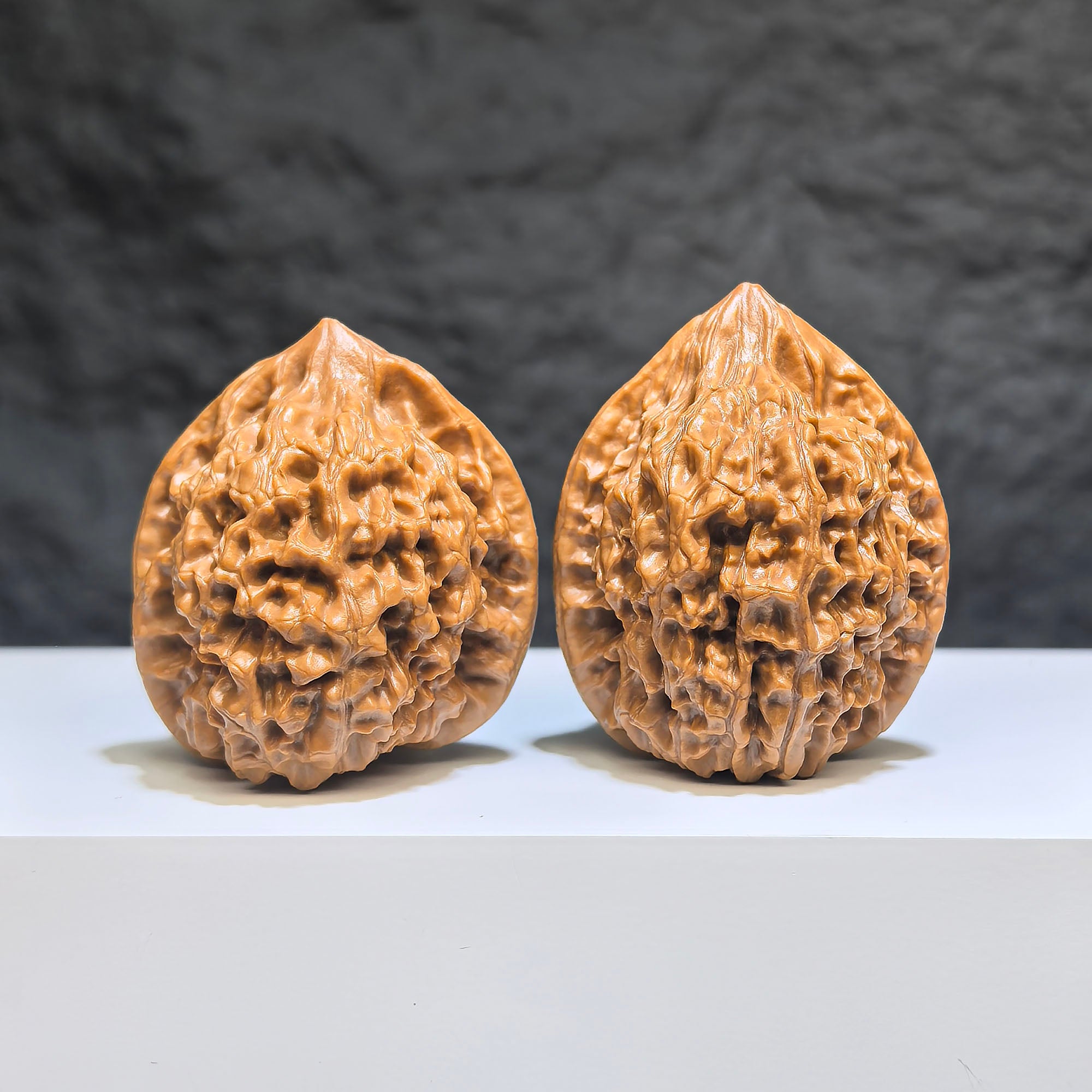 Pair of small Wenwan Art official-style walnut miniatures, 34mm x 33mm, showcasing detailed craftsmanship and natural walnut textures.