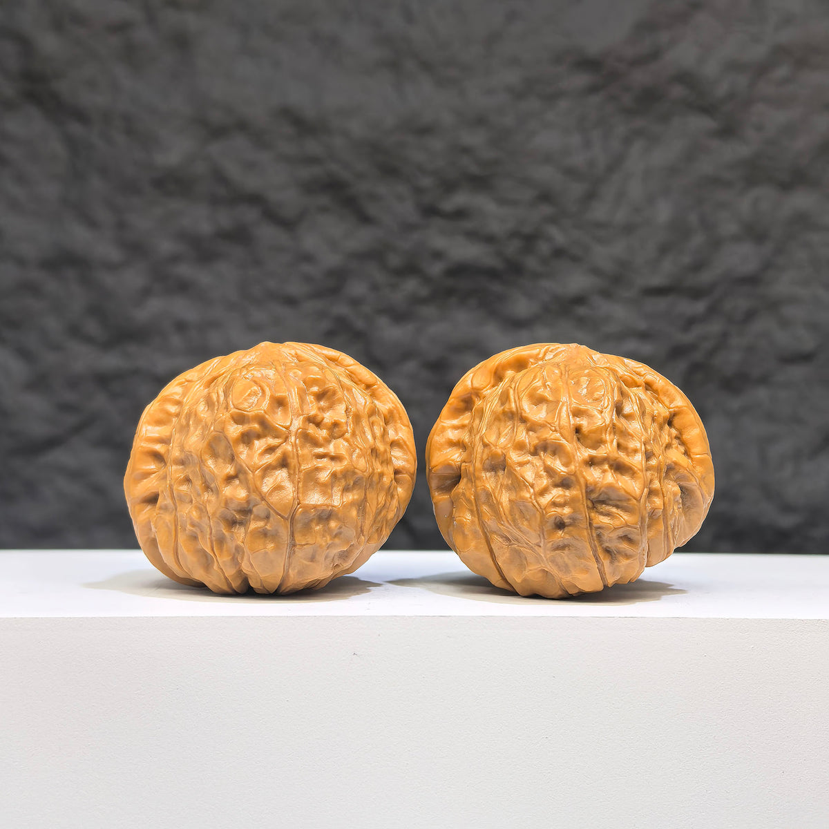 Pair of small Wenwan Walnut miniatures with pumpkin-shaped carvings, crafted by Wenwan Art, measuring approximately 38mm by 40mm.
