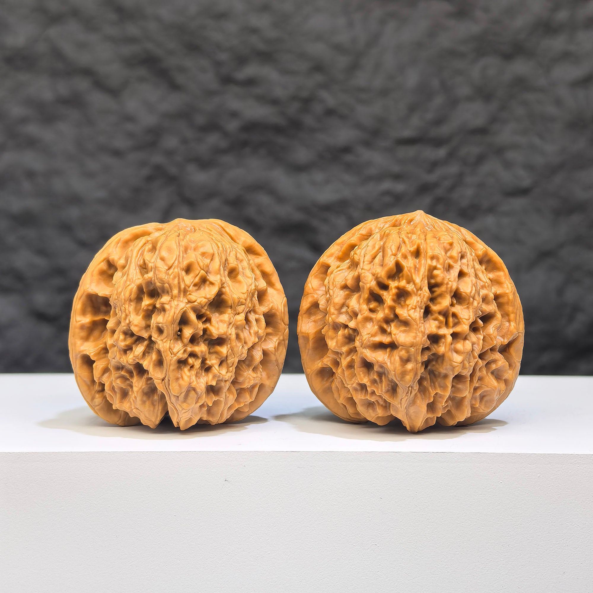 Pair of Yuhua Stone Wenwan walnuts from Wenwan Art, 37mm x 34mm, showcasing polished natural stone with intricate patterns.