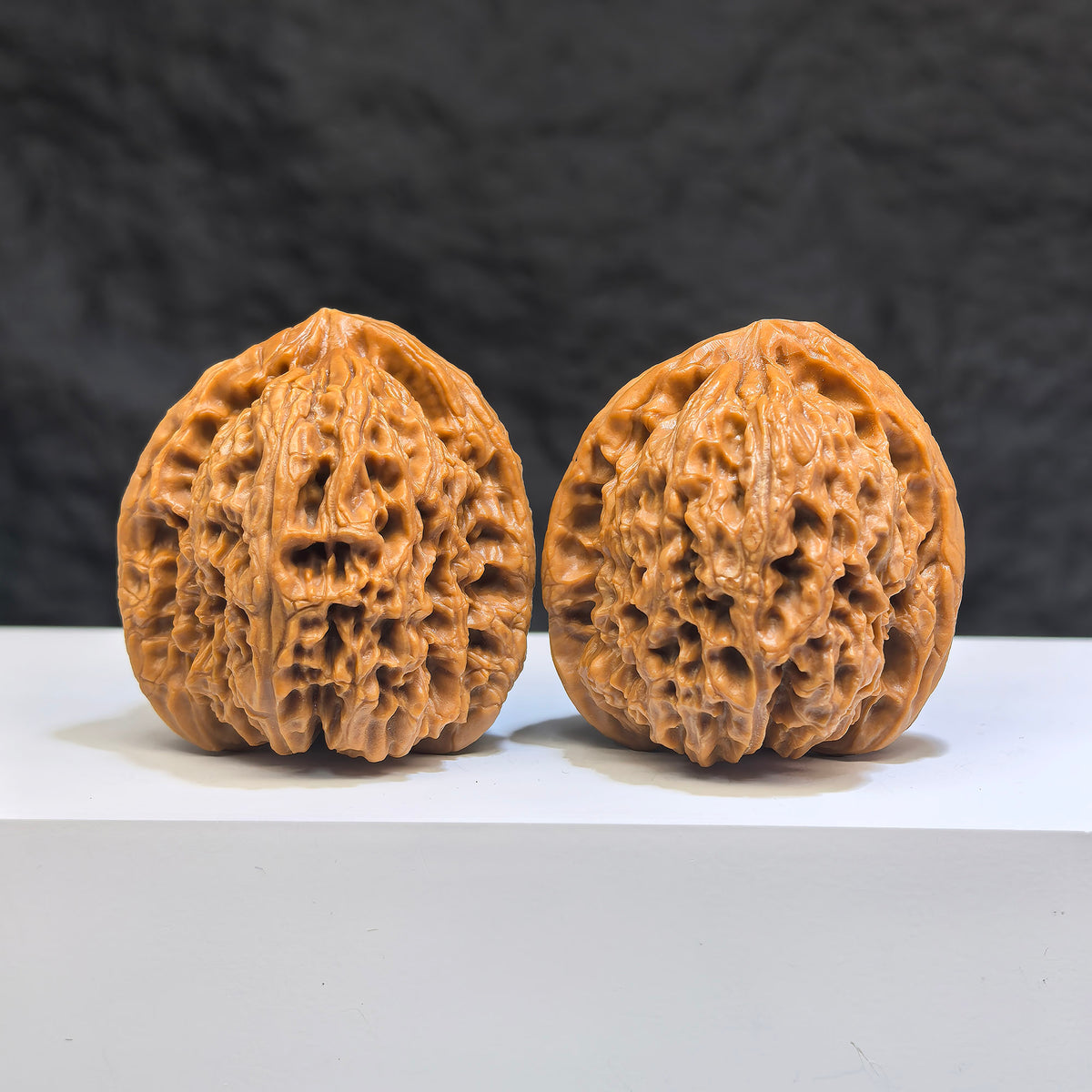 Pair of Nanjiangstone Wenwan walnuts from Wenwan Art, 38mm x 39mm, showcasing smooth, polished walnut-shaped carvings.