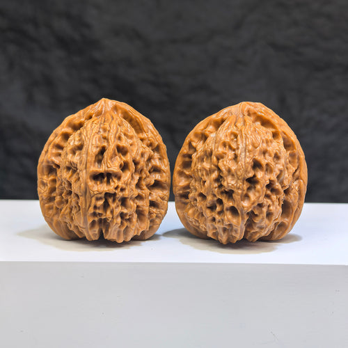 Pair of Nanjiangstone Wenwan walnuts from Wenwan Art, 38mm x 39mm, showcasing smooth, polished walnut-shaped carvings.