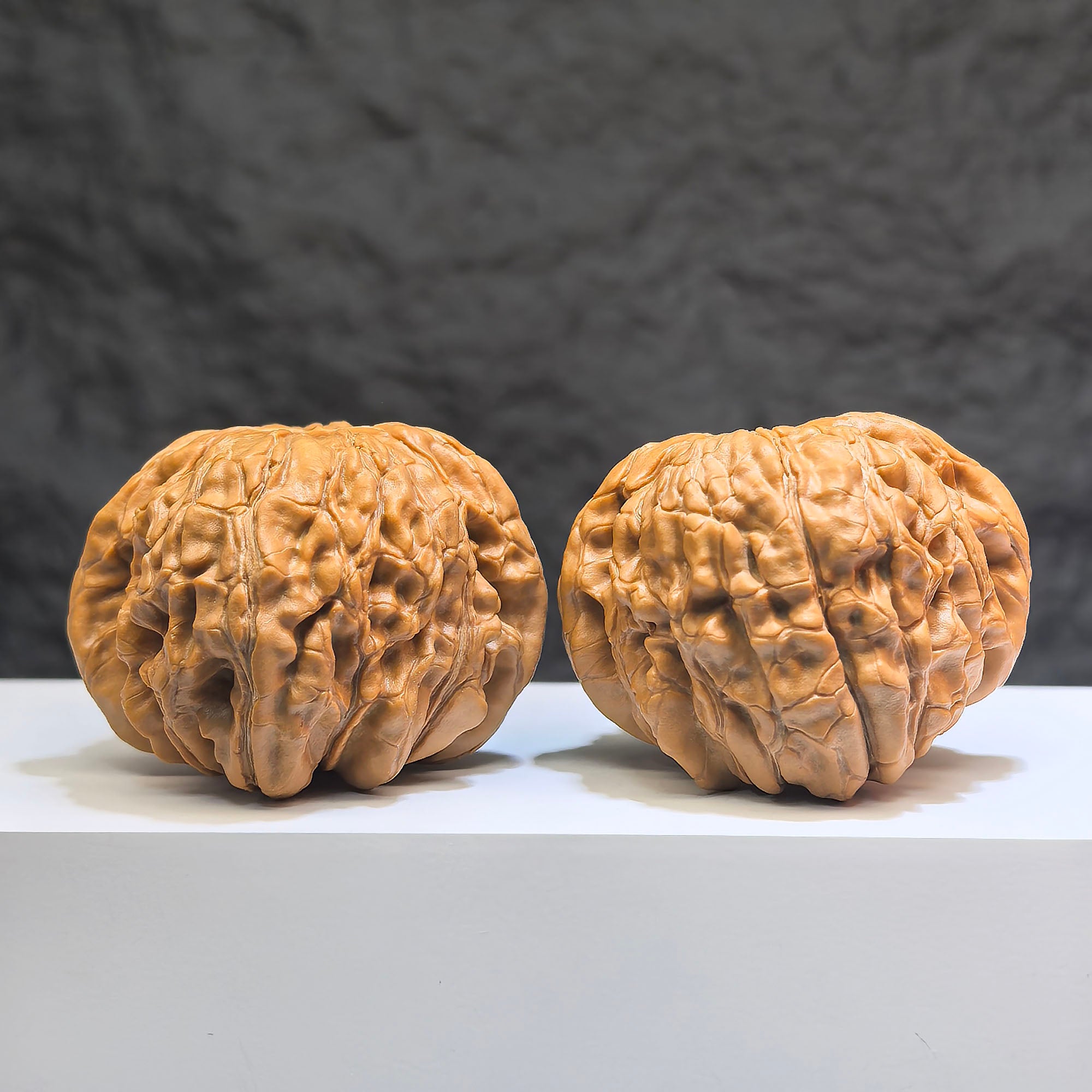 Pair of Huakun Dragon Wenwan walnuts from Wenwan Art, featuring dragon-scale patterns, measuring 49x51mm, natural walnut texture.