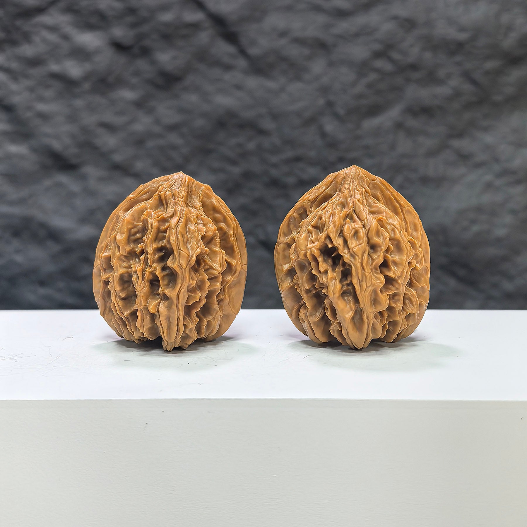 Pair of Tongtian Eight Wenwan walnuts from Wenwan Art, 33mm size, showcasing polished natural walnut surface and intricate patterns.