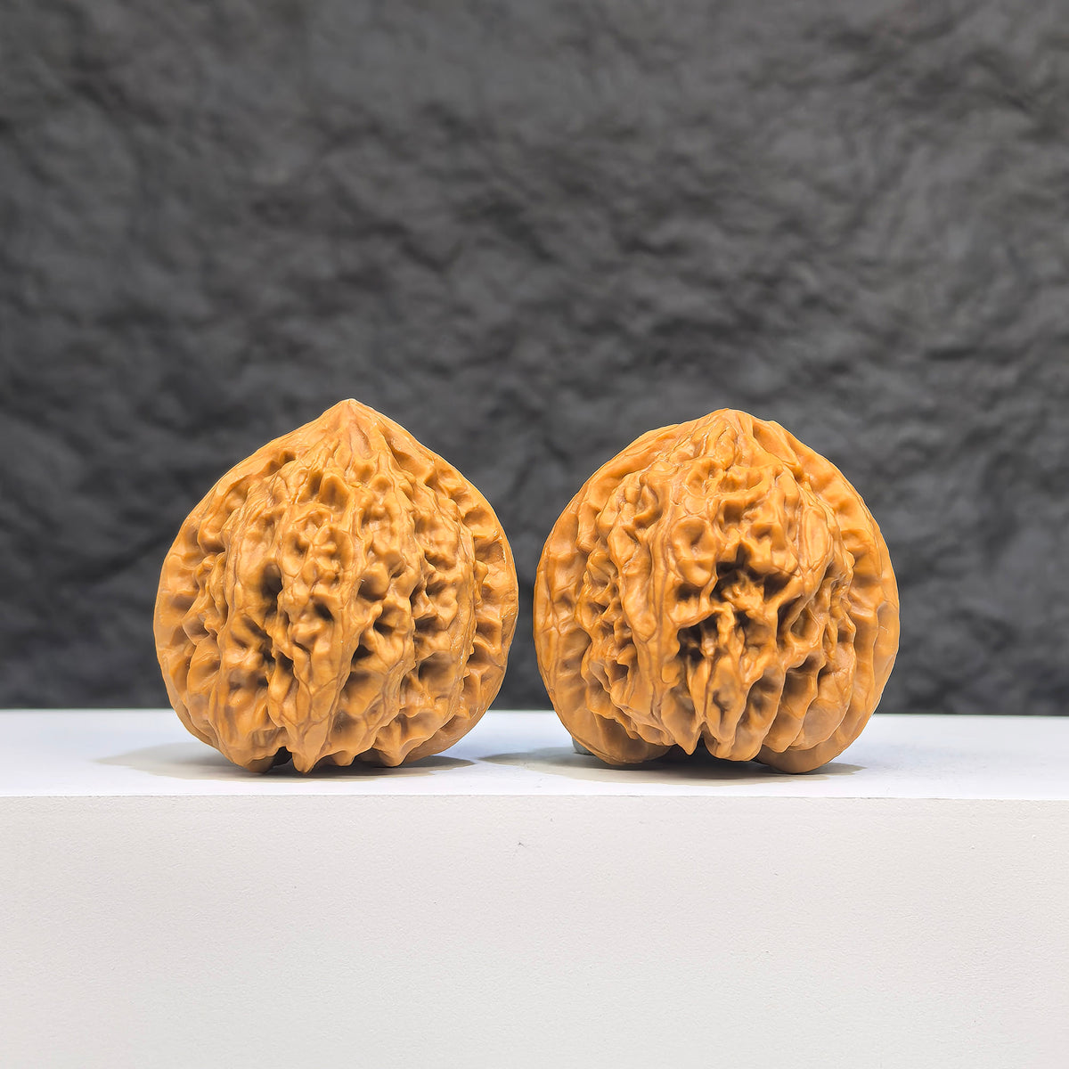 Pair of Golden Taurus Wenwan Walnuts by Wenwan Art, 36mm x 35mm, featuring intricate golden-colored walnut carvings.