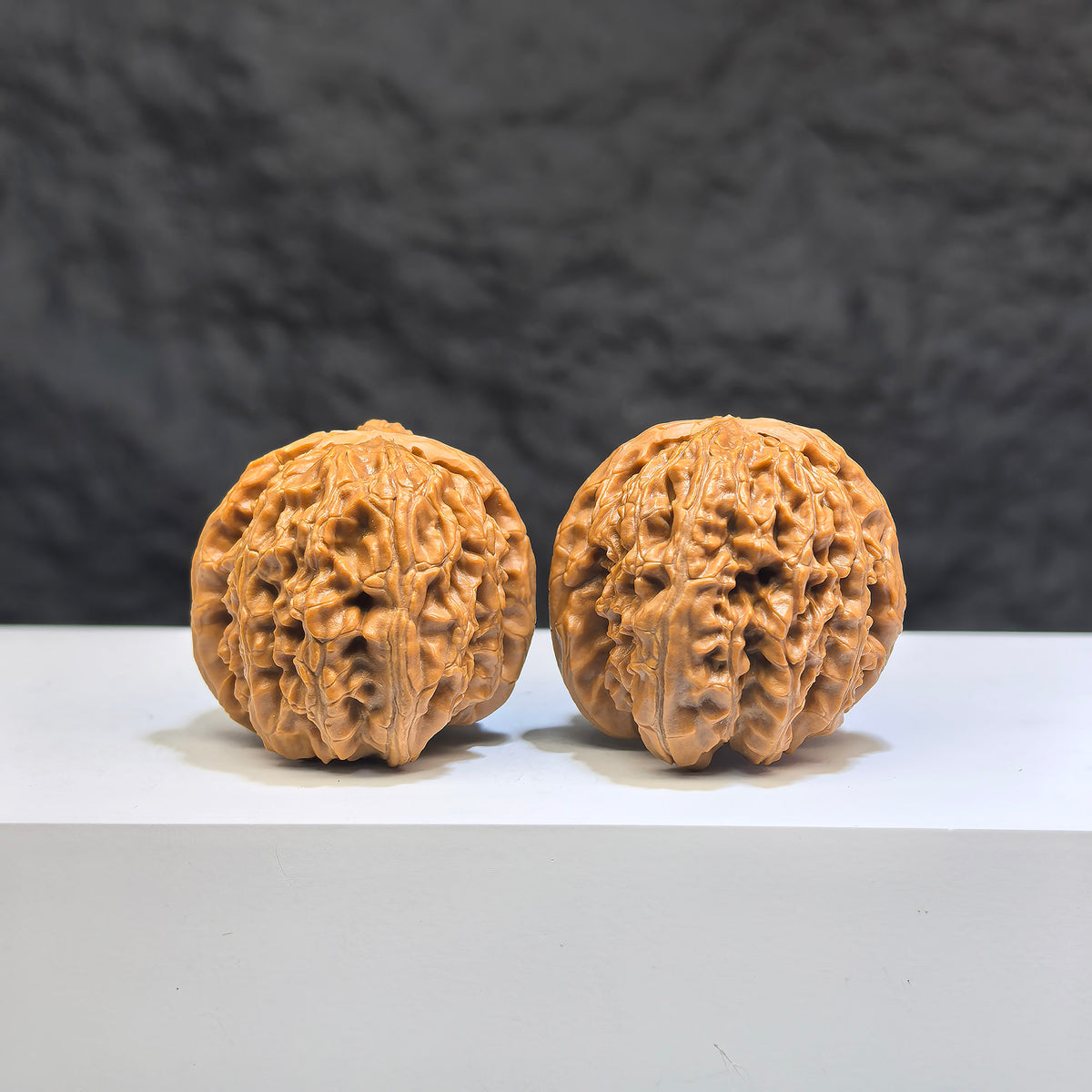 Pair of Pocket White Lion Wenwan Walnuts, miniature 32mm x 34mm carved walnuts by Wenwan Art, detailed white lion figures.