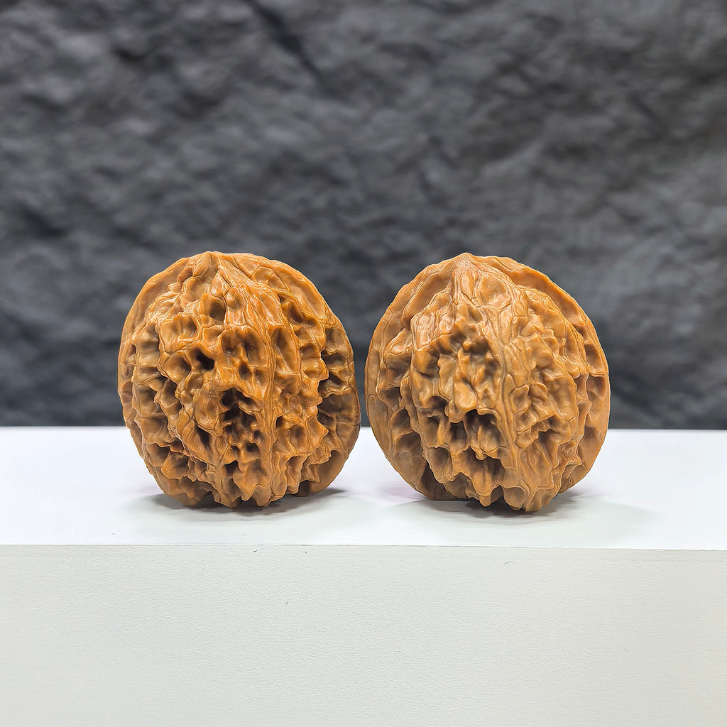 Pair of "Apple Garden" Wenwan Walnuts by Wenwan Art, 36mm, featuring detailed carved walnut surfaces.
