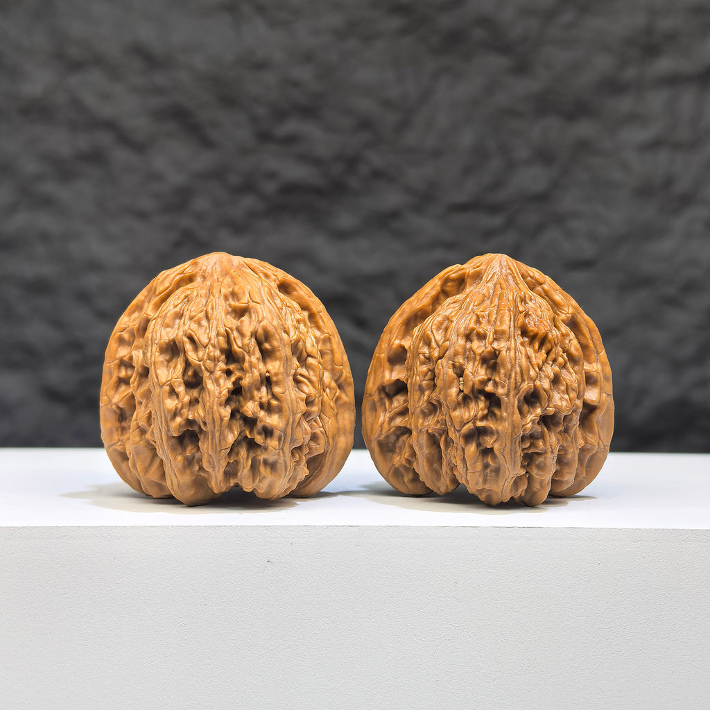 Pair of Peach Heart Concave Base Ruby Wenwan Walnuts from Wenwan Art, 35mm x 33mm, showcasing deep-base walnut with reddish hue.