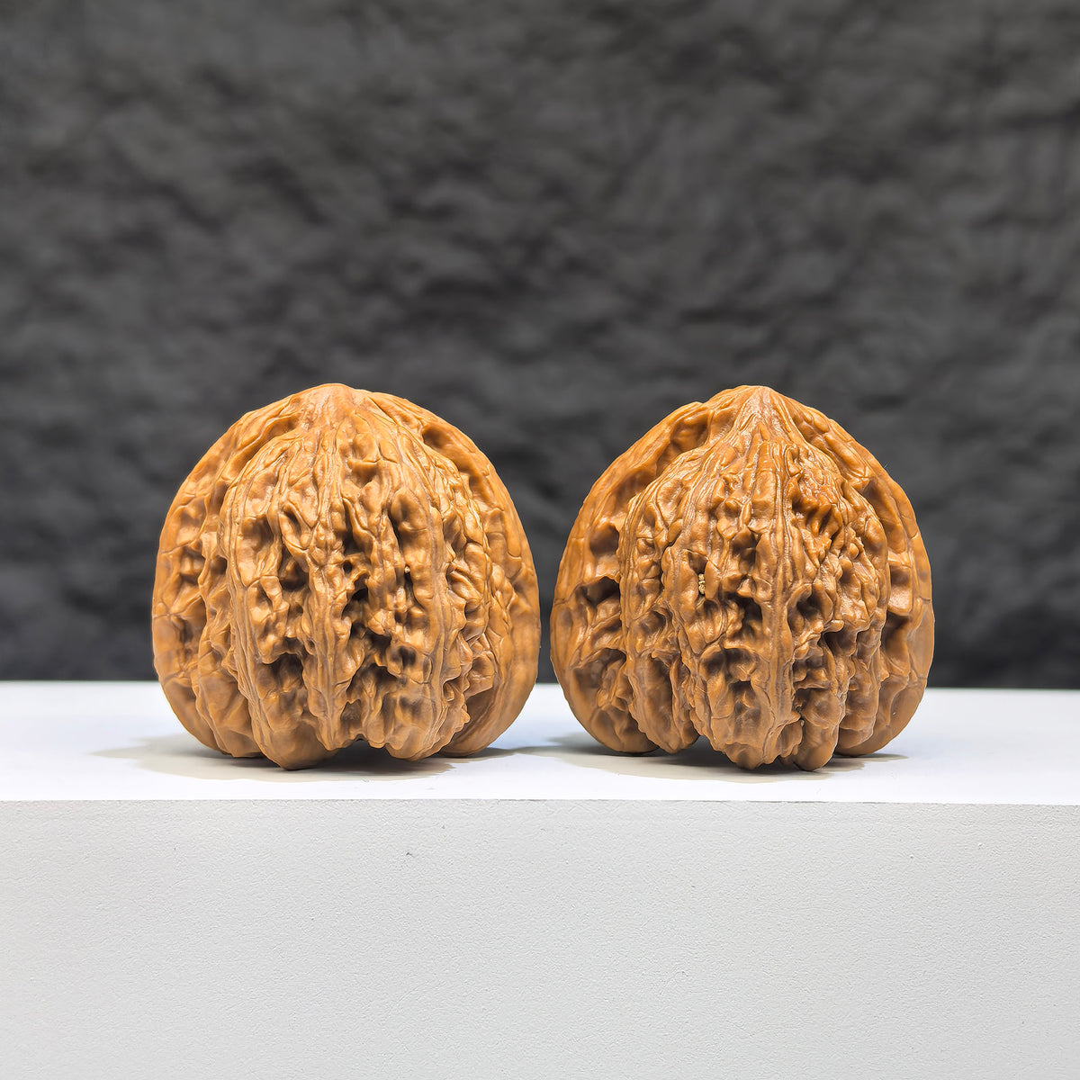 Pair of Peach Heart Concave Base Ruby Wenwan Walnuts from Wenwan Art, 35mm x 33mm, showcasing deep-base walnut with reddish hue.