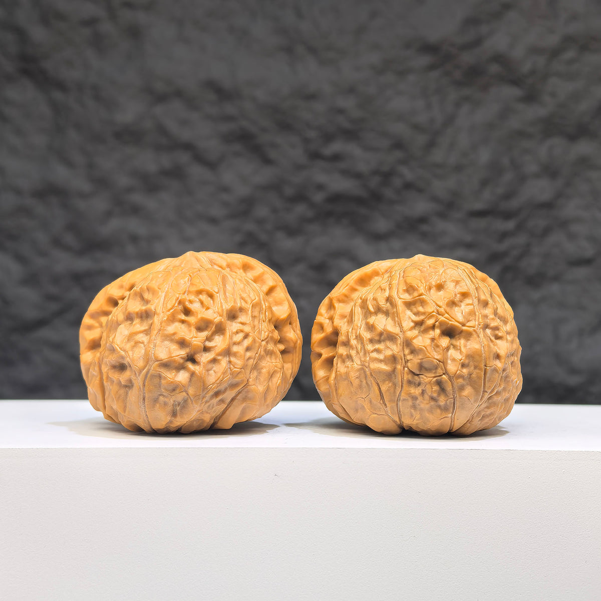 Pair of Wenwan Art Hundred Beasts Lion Head Wenwan walnuts, 43mm x 40mm, featuring detailed lion head carvings.