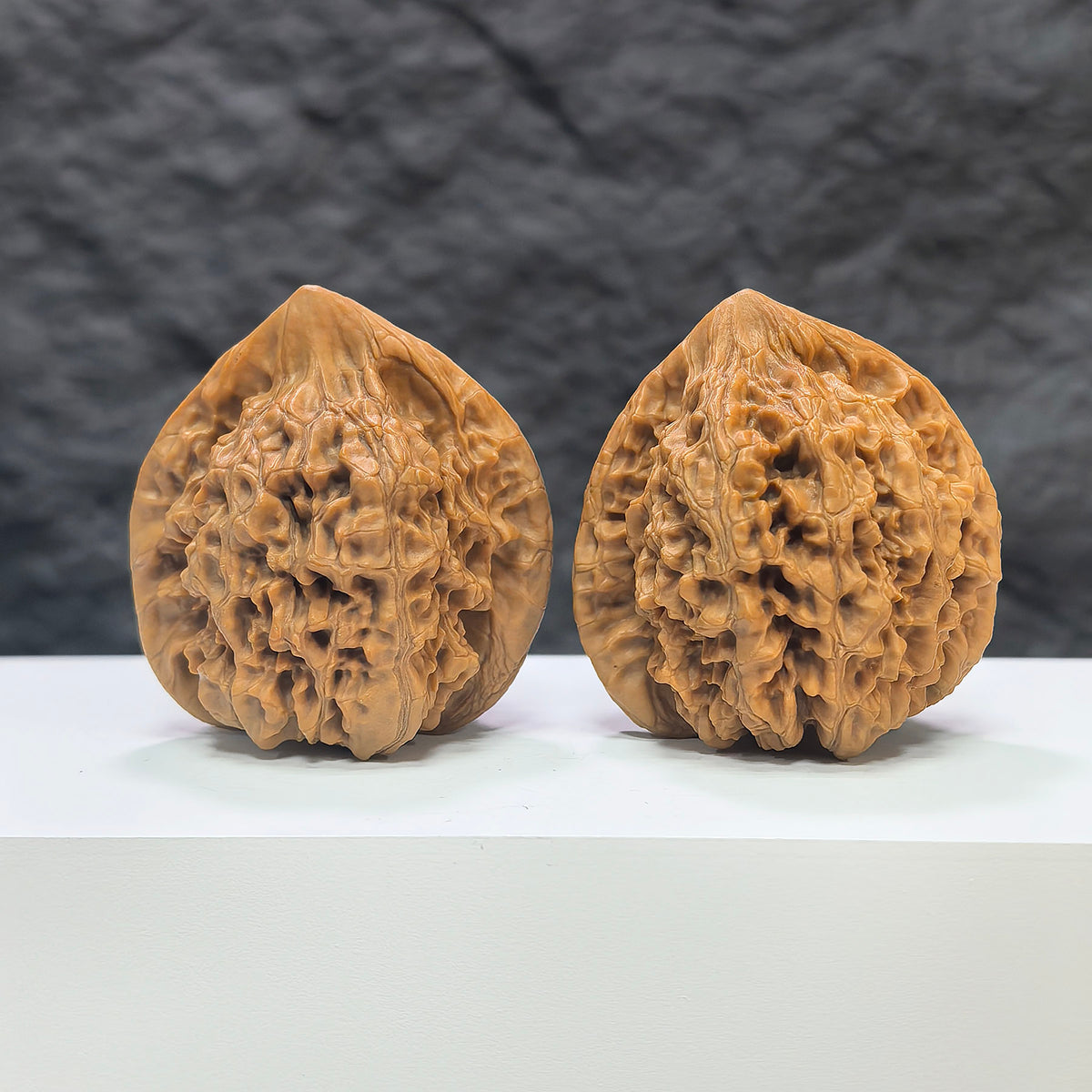 Pair of Wenwan Art Official Hat Wenwan walnuts, 44mm x 40mm, showcasing smooth, polished walnut carvings with intricate details.