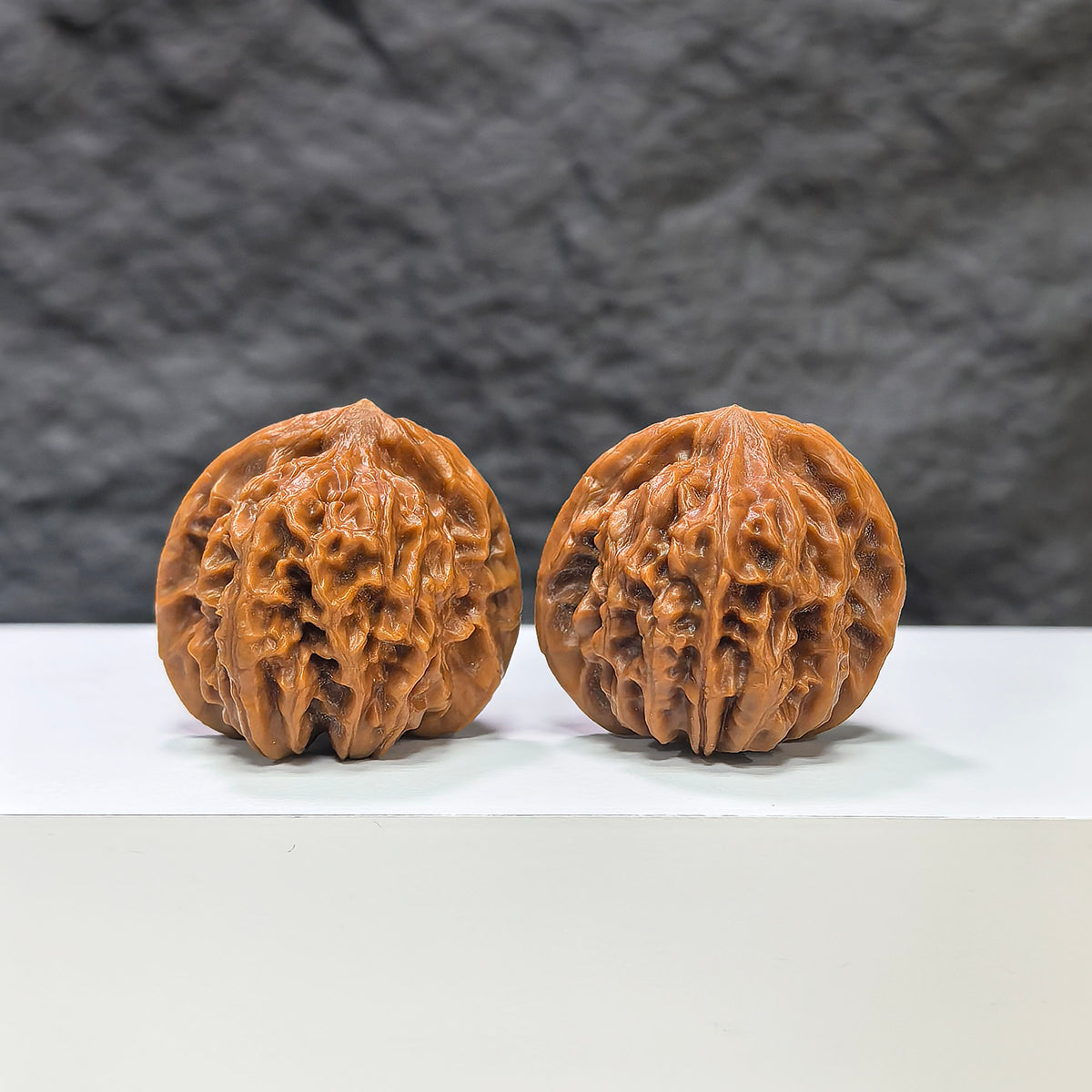 Pair of Pocket Sizuolou Wenwan walnuts by Wenwan Art, miniature 33mm size, showcasing detailed carved walnut art.