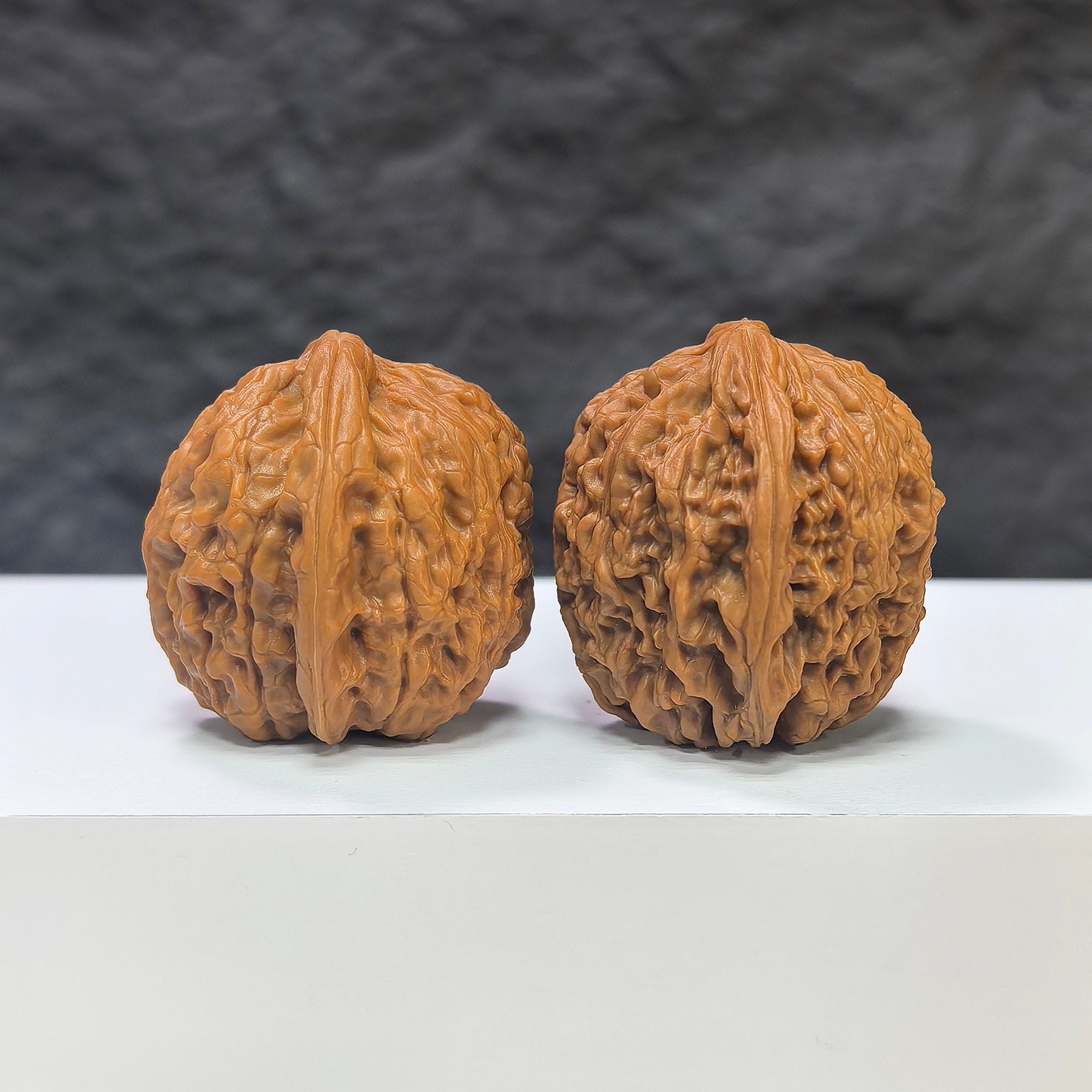 Miniature Wenwan Walnut pair featuring pocket-sized meteorite sycees, crafted by Wenwan Art, measuring 31mm each.
