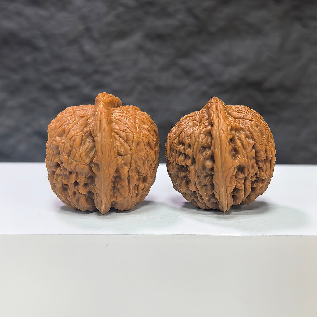 Pair of Wenwan Art Pocket Meteorite Sycee miniature walnuts, 30mm x 31mm, with detailed natural stone textures and polished surfaces.