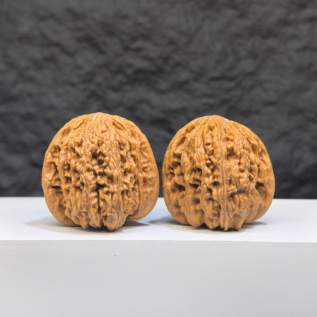 Pair of "Ruby" Classic Wenwan Walnuts by Wenwan Art, 36mm diameter, featuring rich red gemstone appearance and intricate craftsmanship.