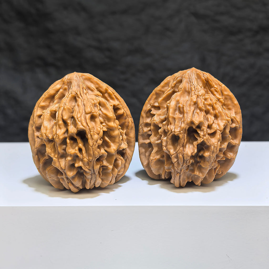 Pair of Tongtian Eight Wenwan walnuts by Wenwan Art, showing polished surface and natural wood grain, size approximately 40mm.
