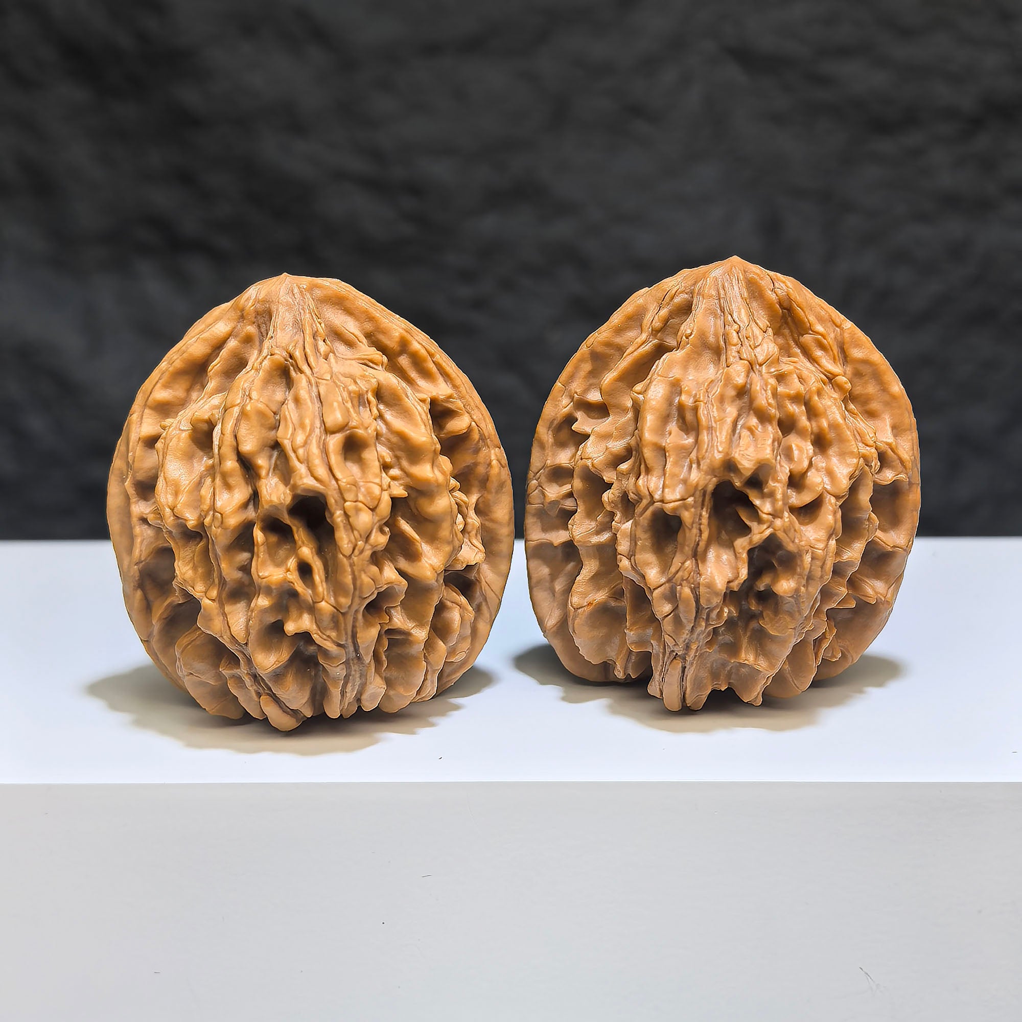 Pair of Tongtian Eight Wenwan walnuts by Wenwan Art, showing polished surface and natural wood grain, size approximately 40mm.