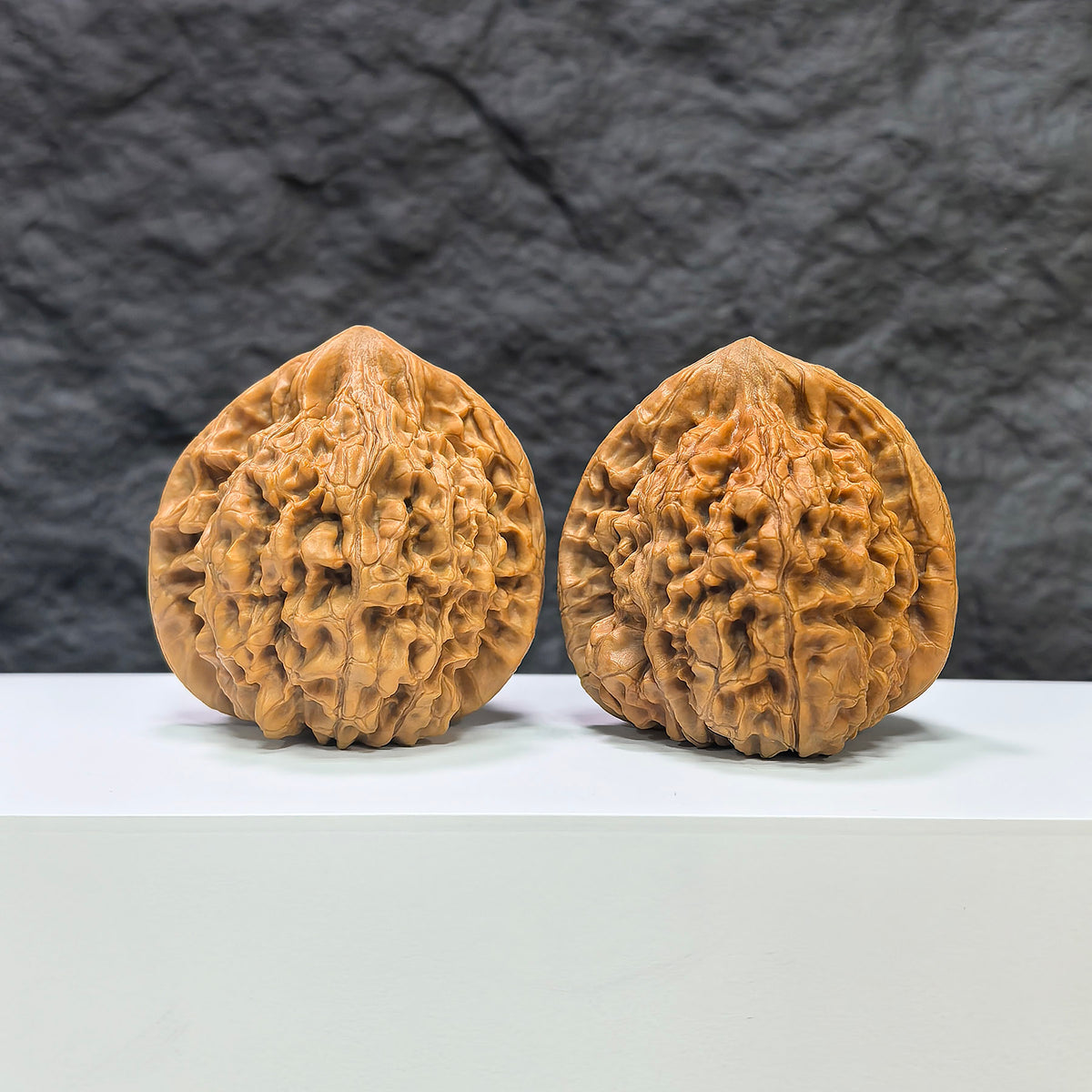 Pair of large Wenwan Art official Wenwan walnuts, 48mm x 45mm, showcasing smooth, polished walnut shells with intricate patterns.