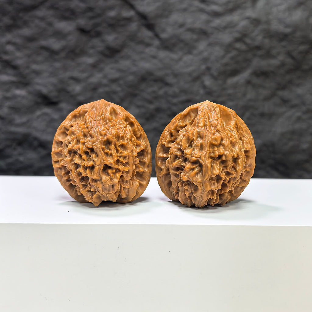 Pair of Golden Kylin Wenwan walnuts by Wenwan Art, featuring natural golden-brown tones and intricate carving details.