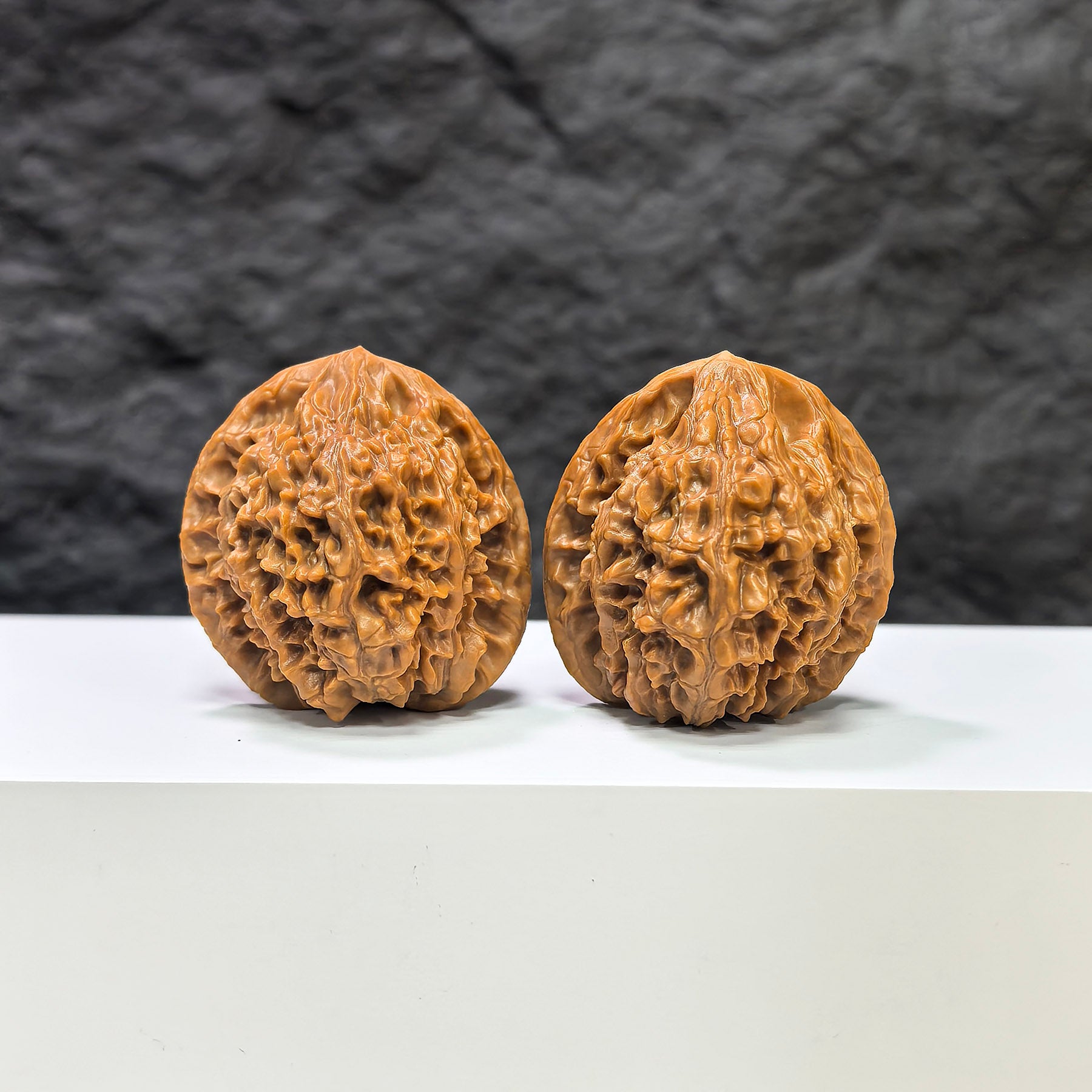 Pair of Golden Kylin Wenwan walnuts by Wenwan Art, featuring natural golden-brown tones and intricate carving details.