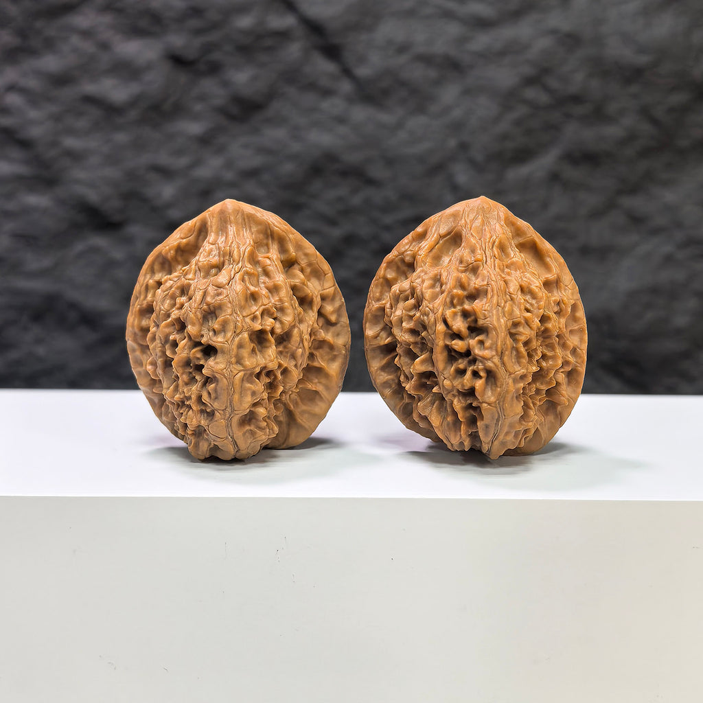 Pair of Golden Kylin Wenwan walnuts from Wenwan Art, 36mm x 37mm, featuring intricate natural wood grain details.