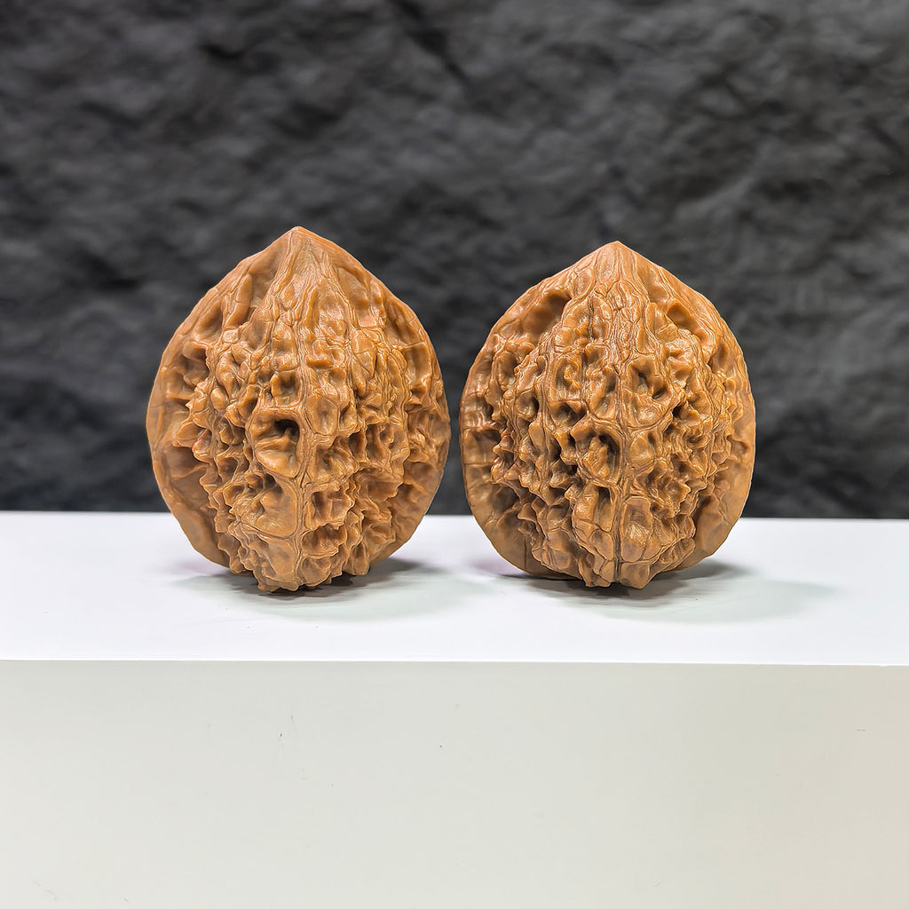 Pair of Golden Kylin Wenwan walnuts from Wenwan Art, featuring intricate carvings, measuring 37mm by 36mm.