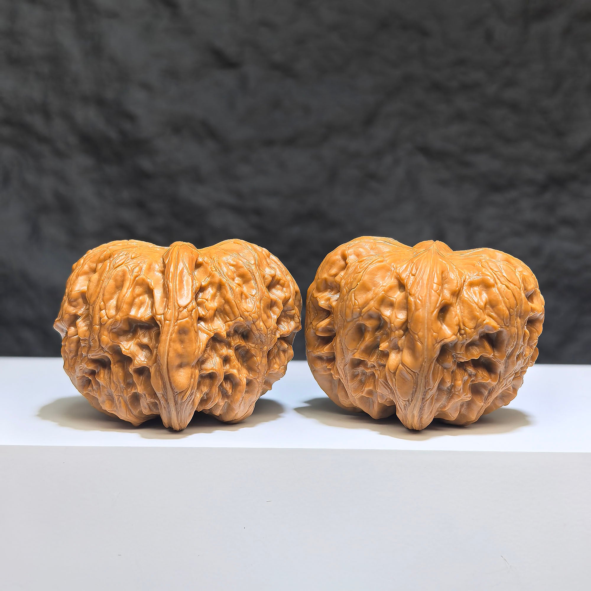 Pair of Pinggu Sycee Yuanbao-shaped Wenwan walnuts from Wenwan Art, 39mm x 46mm, showcasing detailed carved ingot design.
