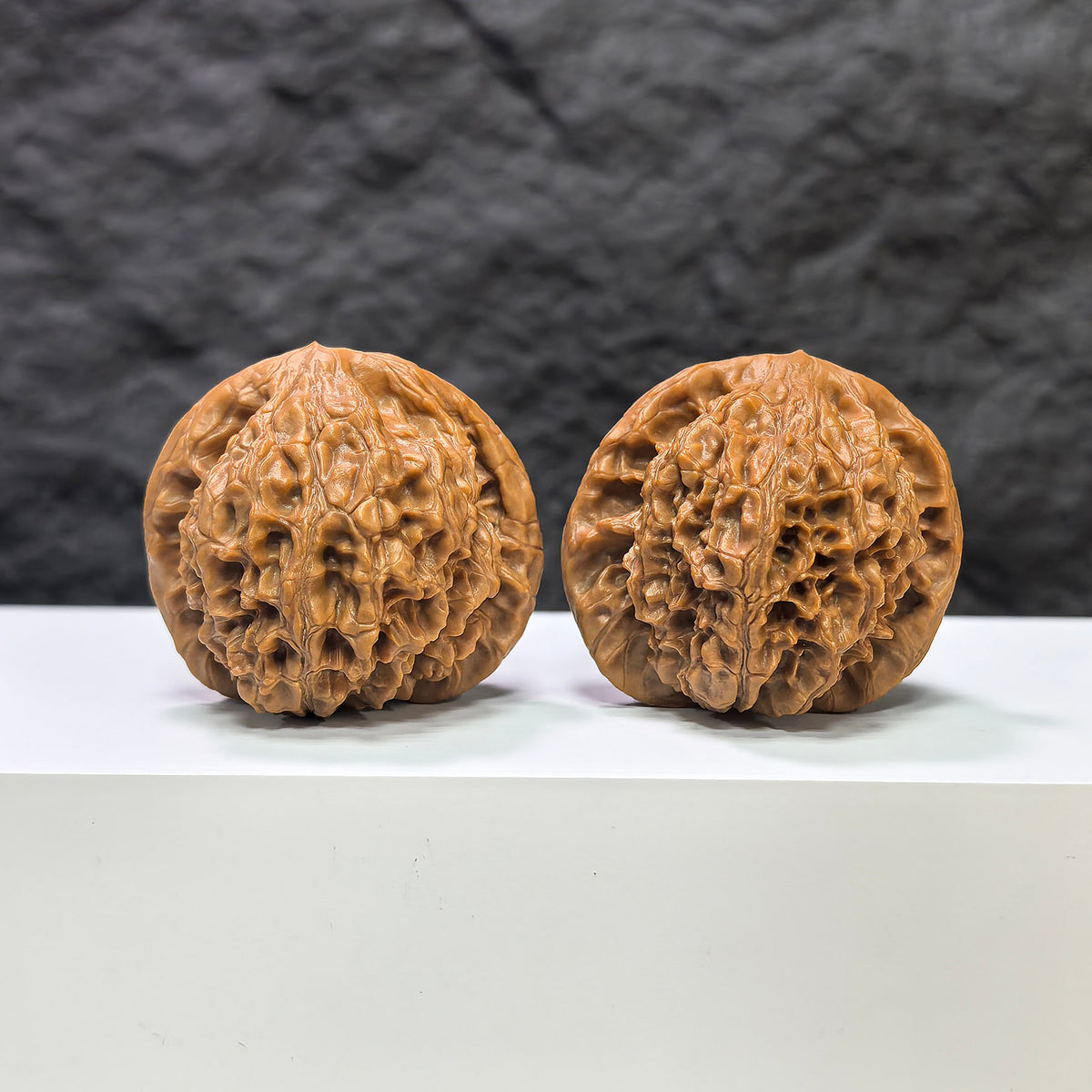 Pair of Golden Kylin Wenwan walnuts from Wenwan Art, featuring natural golden color and detailed carving, measuring 42mm x 40mm.