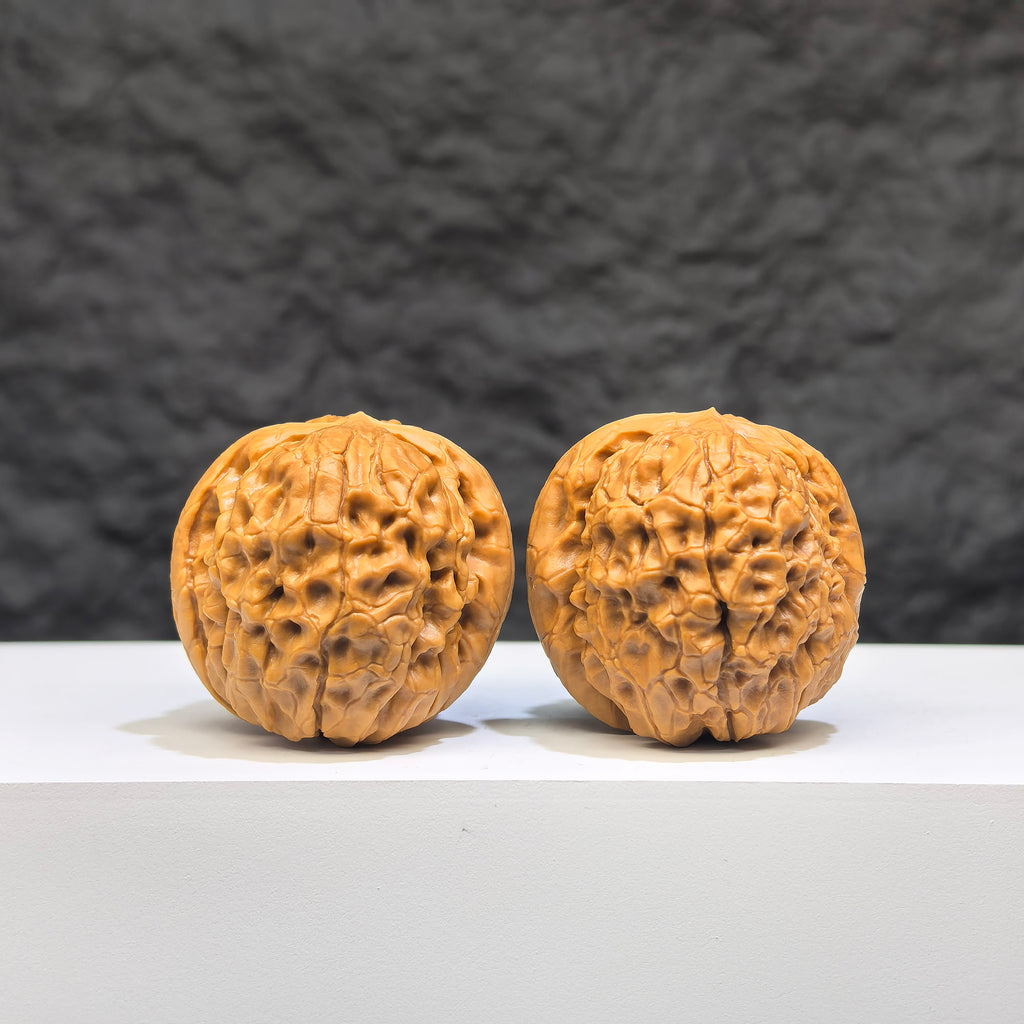 Miniature Wenwan Walnut pair with Oracle Bone Script carvings, 33mm x 31mm, crafted by Wenwan Art, showcasing detailed traditional engraving.