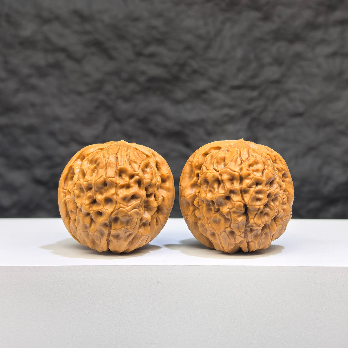 Miniature Wenwan Walnut pair with Oracle Bone Script carvings, 33mm x 31mm, crafted by Wenwan Art, showcasing detailed traditional engraving.