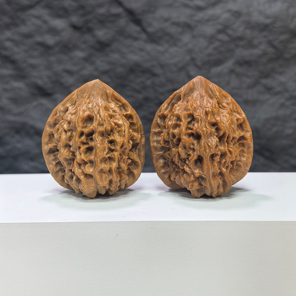 Pair of Wenwan Art Official Hat Classic Wenwan Walnuts, 40mm x 38mm, featuring detailed carved designs on smooth walnut surfaces.