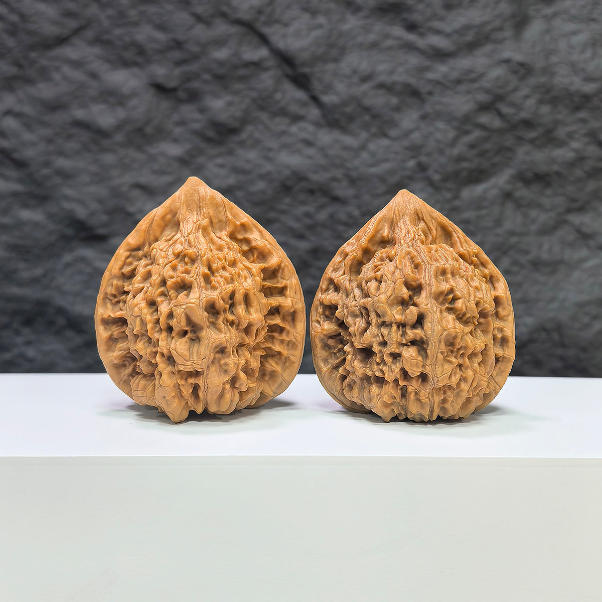 Pair of Wenwan Art Concave Base Peach Heart Official Hats, deep-base Wenwan walnuts with 43mm by 40mm size, natural wood appearance.