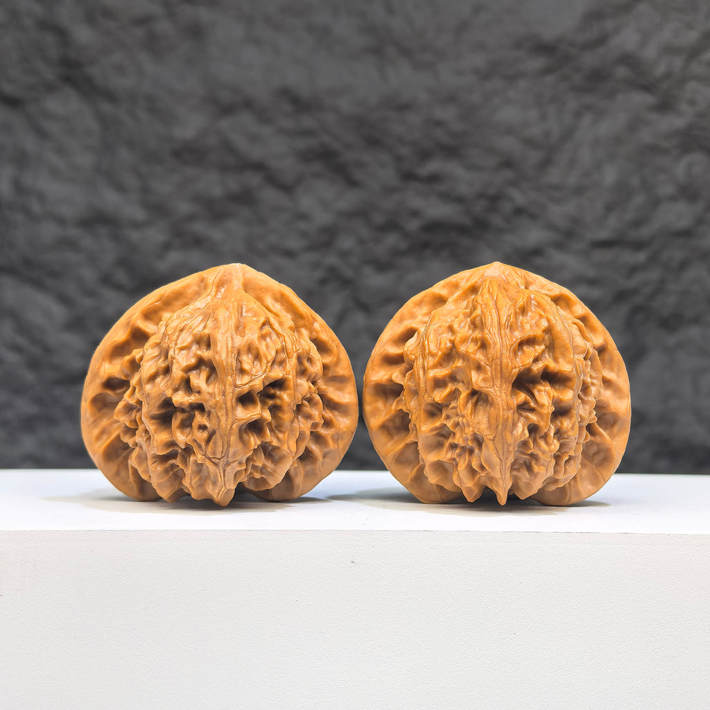 Pair of Peach Heart Palace Lantern Wenwan walnuts from Wenwan Art, 42mm x 38mm, featuring intricate peach heart designs.