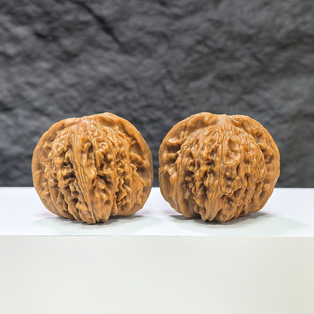 Pair of Sizuolou Wenwan walnuts by Wenwan Art, classic 43mm x 39mm walnut carvings showcasing detailed natural wood textures.