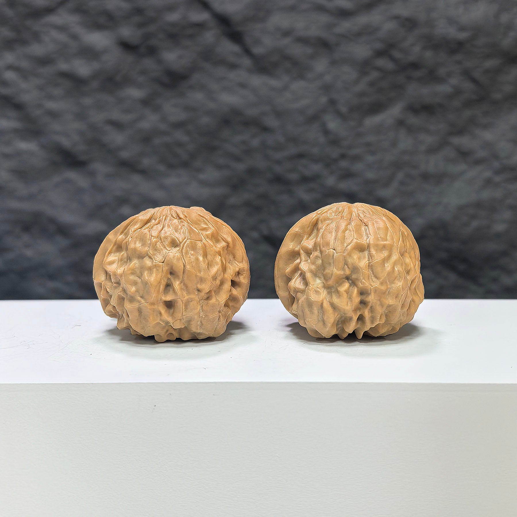 Pair of Golden Toad Vessel Wenwan walnuts by Wenwan Art, featuring detailed carvings and a smooth polished surface.