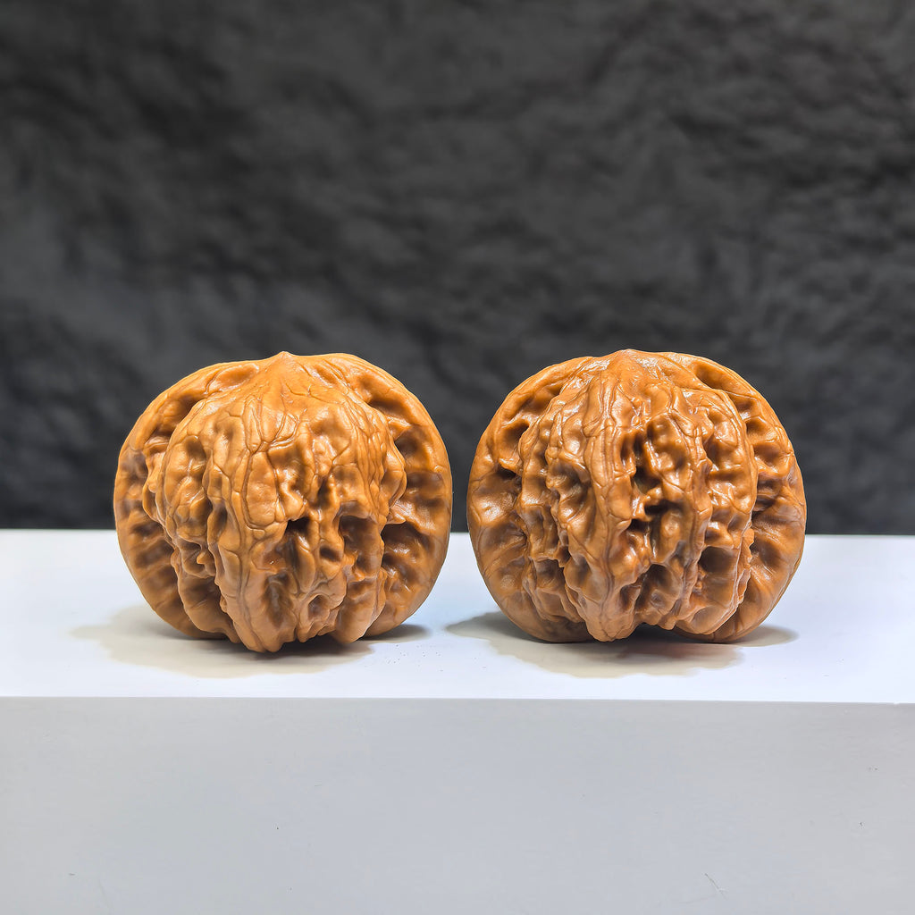 Pair of Wild Wolf Yelang Deep-Carved Wenwan Walnuts from Wenwan Art, showcasing intricate carvings and natural walnut texture.