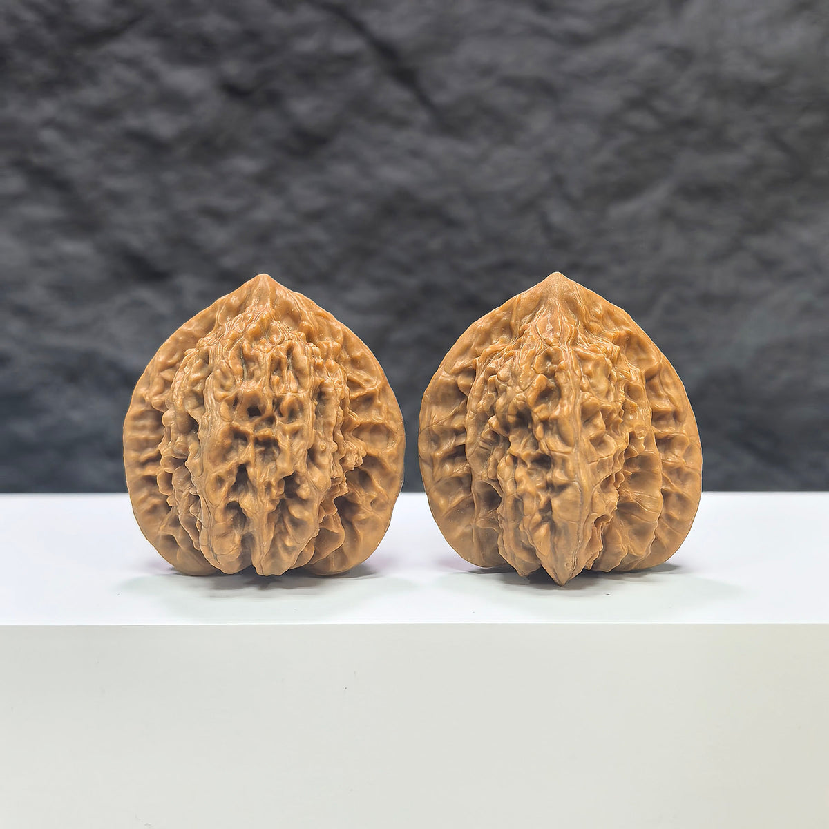 Pair of Peach Heart Xiayunling Wenwan walnuts from Wenwan Art, 38mm size, showcasing smooth, polished walnut carvings with unique patterns.
