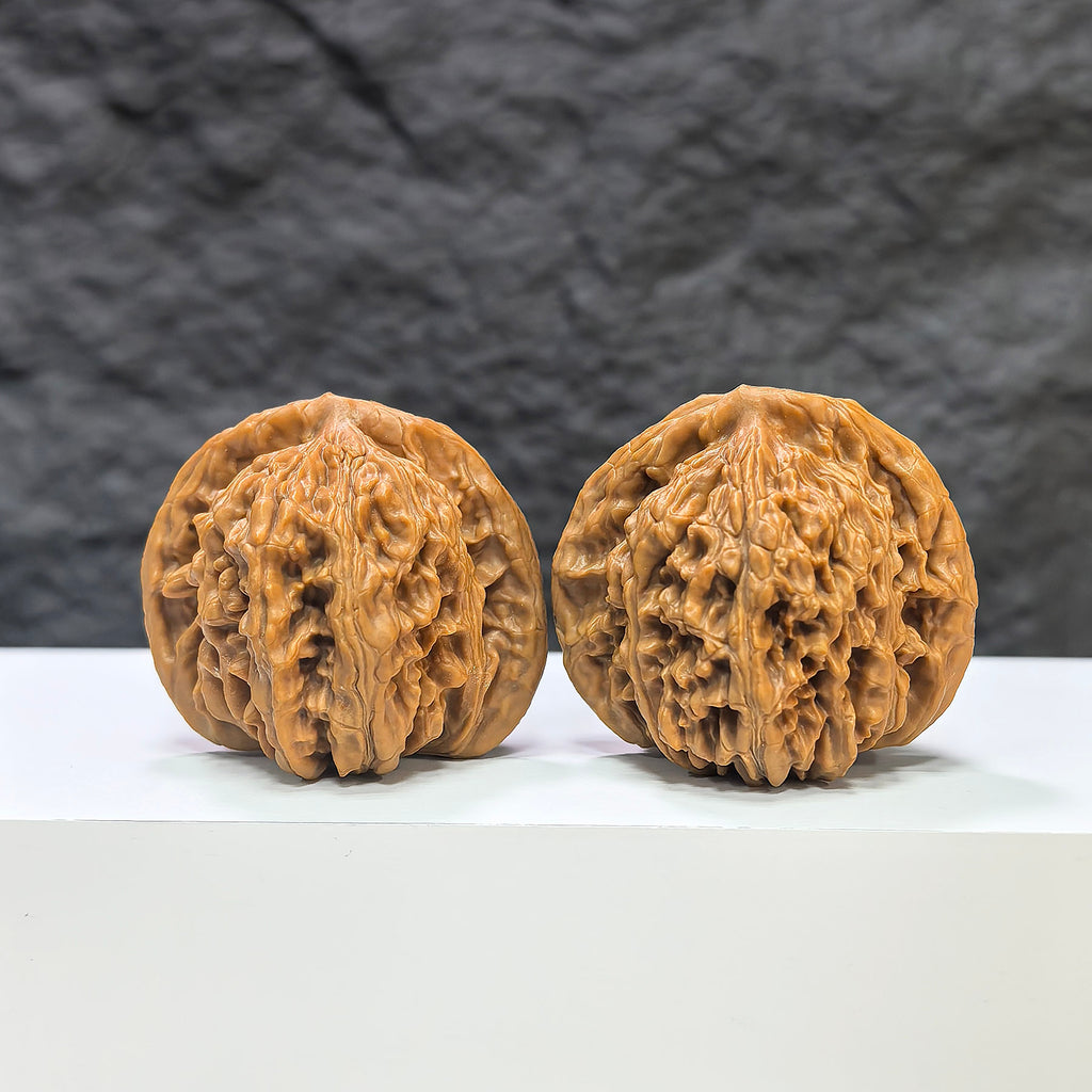 Pair of Sizuolou Wenwan walnuts from Wenwan Art, measuring 41mm and 38mm, showcasing smooth, polished walnut carvings.