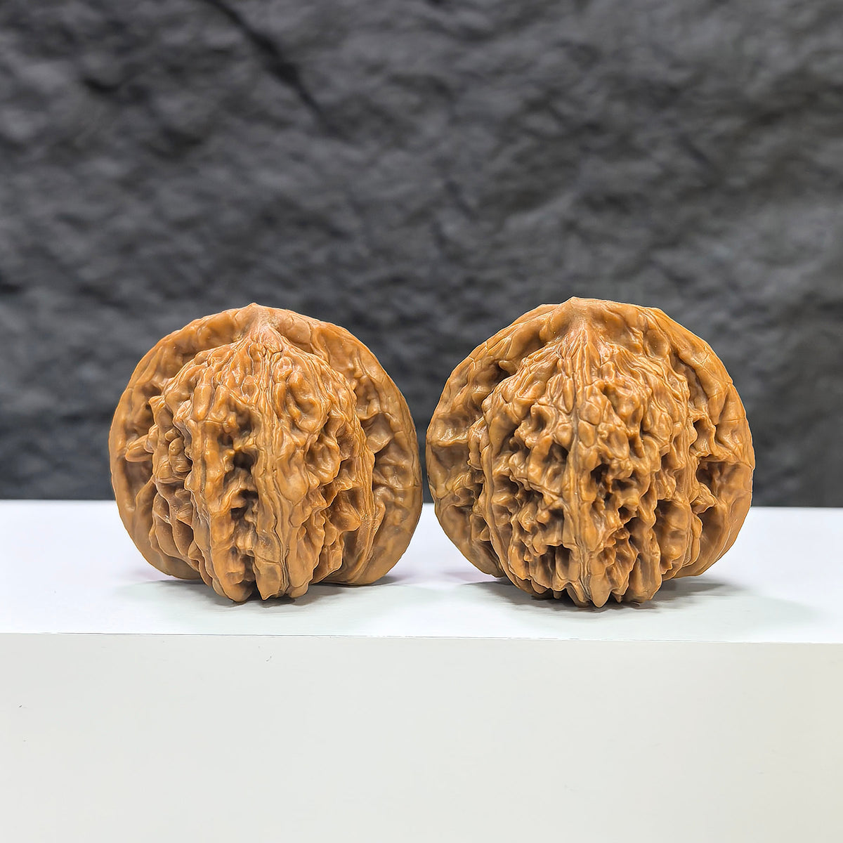 Pair of Sizuolou Wenwan walnuts from Wenwan Art, measuring 41mm and 38mm, showcasing smooth, polished walnut carvings.