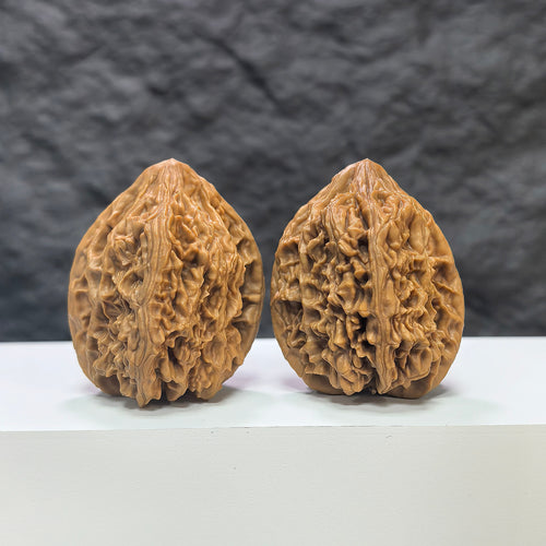 Pair of Beijing Chicken Heart Wenwan walnuts from Wenwan Art, 41mm each, showcasing smooth, rounded walnut surfaces with natural coloration.
