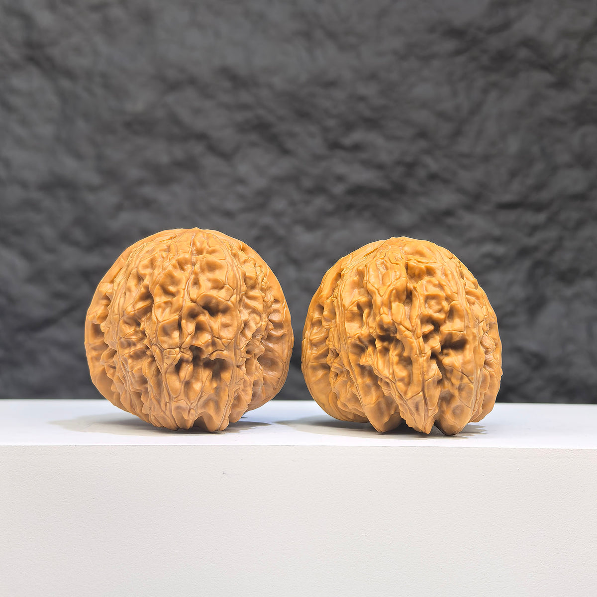 Pair of White Lion Wenwan Walnuts from Wenwan Art, 36mm x 39mm, showcasing intricate carved details and smooth polished surfaces.