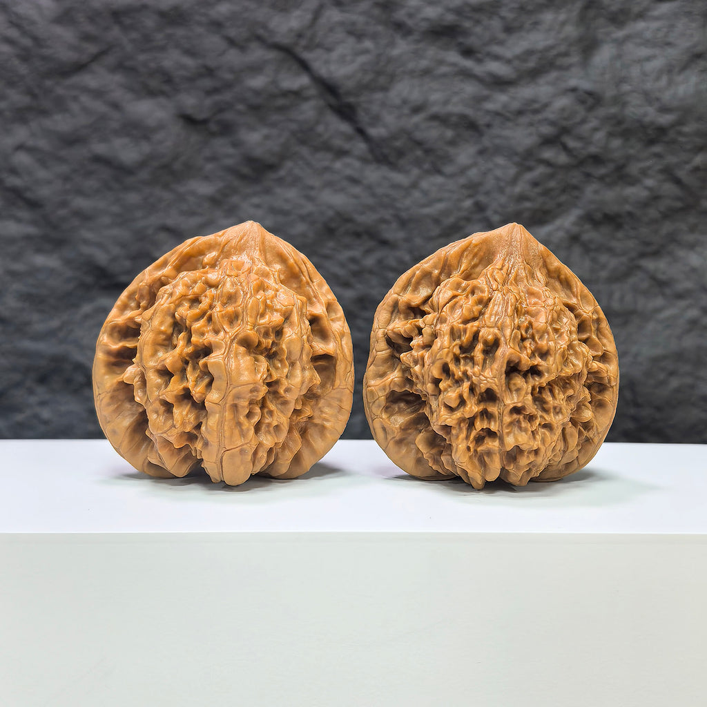 Pair of Wenwan Art large official hat concave base peach heart walnuts, 48mm x 41mm, showcasing detailed walnut carvings.