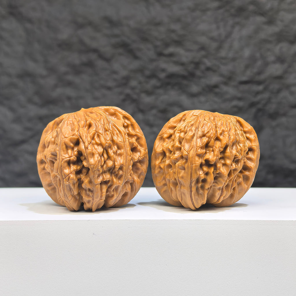 Pair of Butterfly Millstone Wenwan Walnuts by Wenwan Art, featuring intricate butterfly carvings, 38mm x 37mm natural walnut stones.