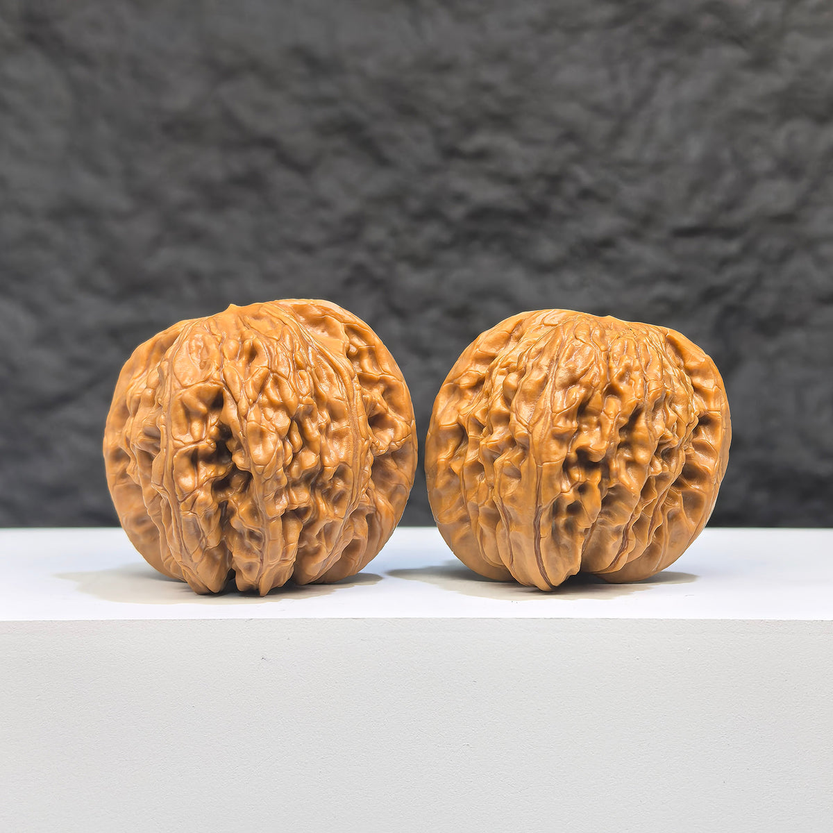 Pair of Butterfly Millstone Wenwan Walnuts by Wenwan Art, featuring intricate butterfly carvings, 38mm x 37mm natural walnut stones.