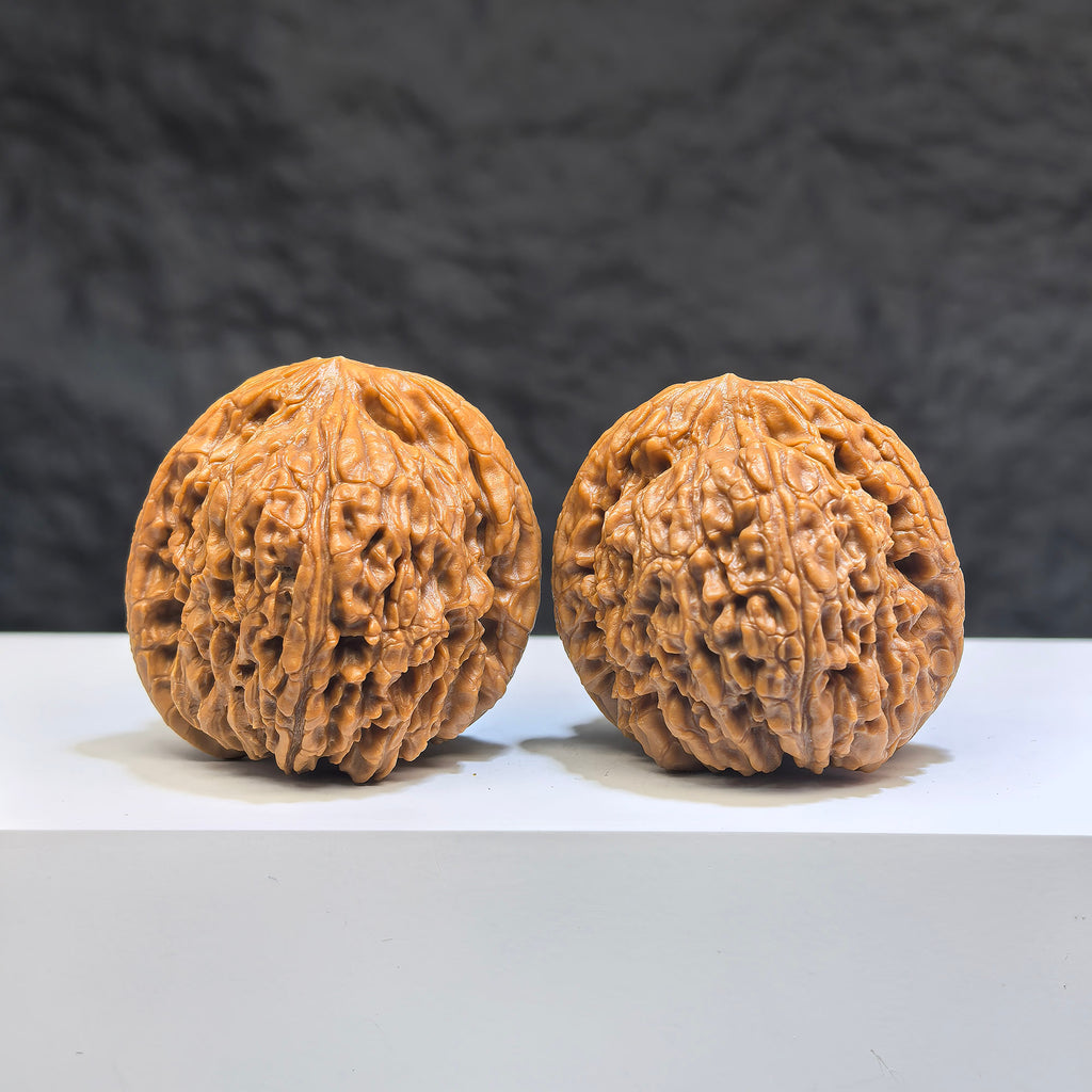 Pair of Nanjiangstone Wenwan walnuts from Wenwan Art, 37mm size, showing detailed natural stone textures and polished surfaces.