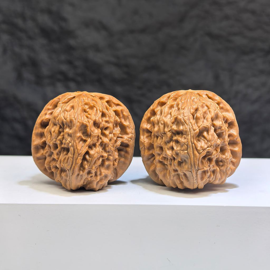 Pair of White Lion Wenwan Walnuts by Wenwan Art, 38mm x 39mm, featuring detailed carvings and natural walnut textures.
