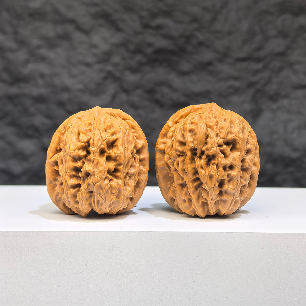Pair of Wenwan Walnut miniature Pocket Yuhua Stone Wenwan art walnuts, 32mm, with intricate natural stone patterns, by Wenwan Art.