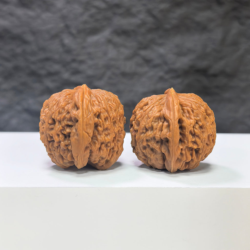 Pair of Nuwa Stone Wenwan walnuts from Wenwan Art, measuring 38mm x 37mm, showcasing polished natural stone surfaces.