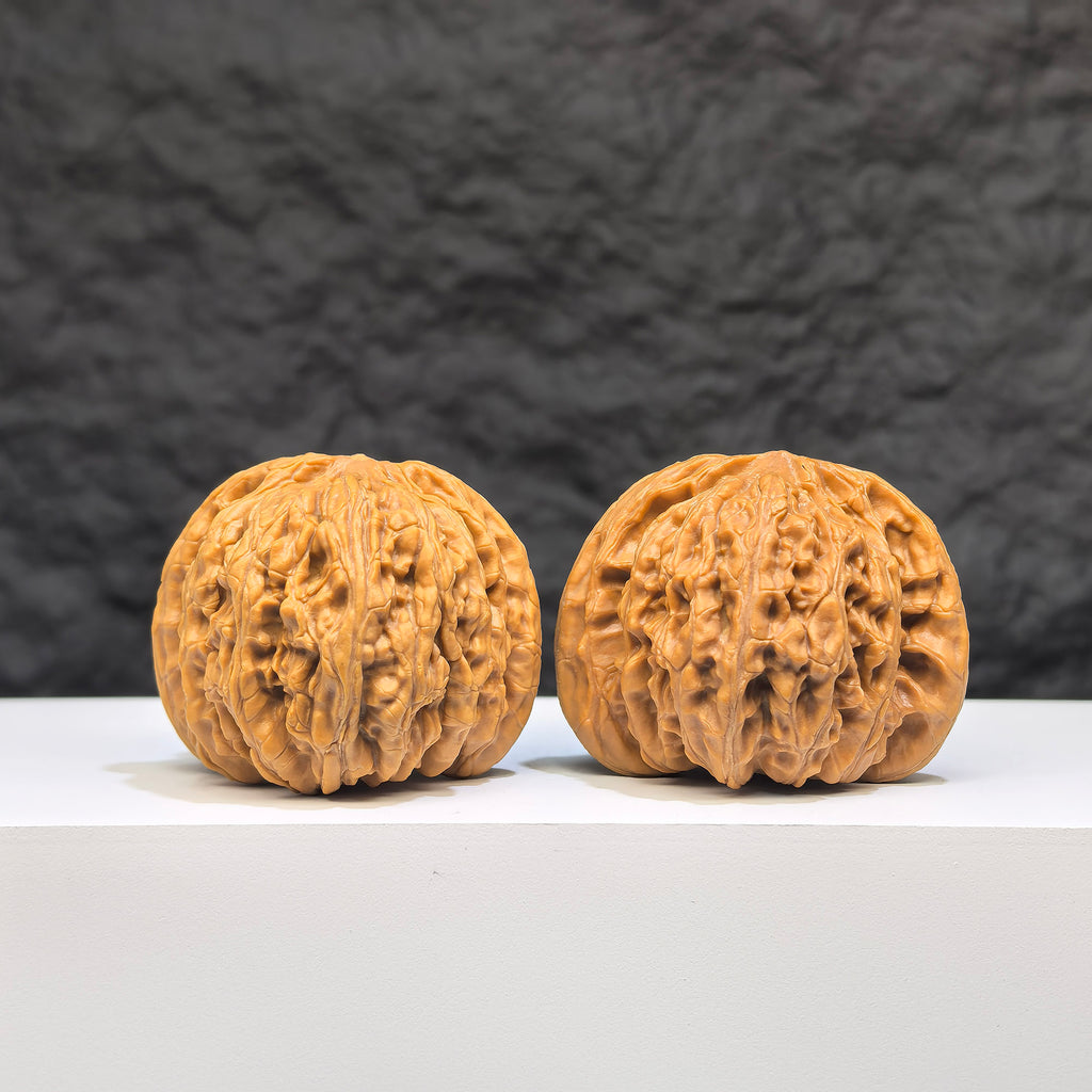Pair of "Ruby" Wenwan Walnuts from Wenwan Art, featuring polished reddish-brown walnut shells with intricate natural patterns.