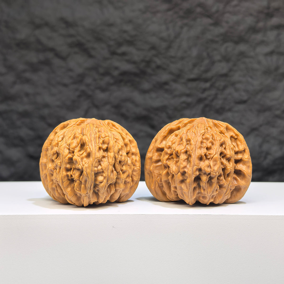 Pair of "Ruby" Wenwan Walnuts from Wenwan Art, featuring polished reddish-brown walnut shells with intricate natural patterns.